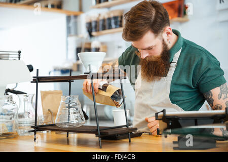 Young man preparing coffee in coffee shop Stock Photo