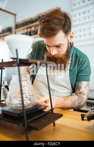 Barista preparing coffee in coffee shop Stock Photo