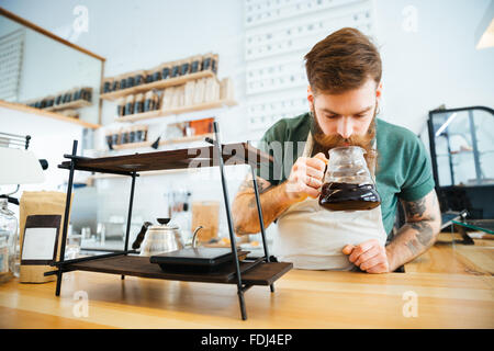 Barista smelling coffee in coffee shop Stock Photo