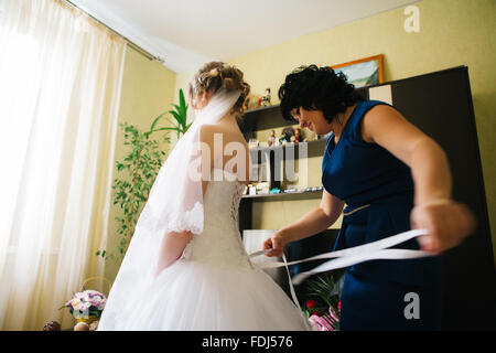 Mom puts young  bride at a  wedding Stock Photo