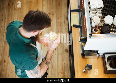 Top view portrait of barista preparing cappucino in coffee shop Stock Photo