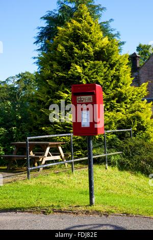 Red post Lamp box on a pole. Blencow, Cumbria, England, United Kingdom. Stock Photo