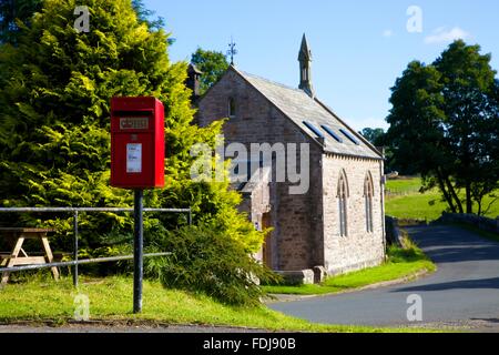 Red post Lamp box on a pole. Blencow, Cumbria, England, United Kingdom. Stock Photo