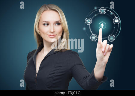 Young woman pressing various collection of high tech buttons Stock Photo