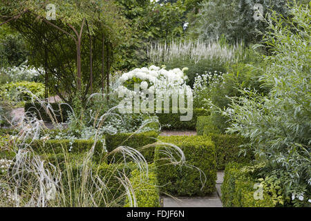 Stipa barbata in the foreground of the White Garden at Sissinghurst Castle Garden, near Cranbrook, Kent. Stock Photo