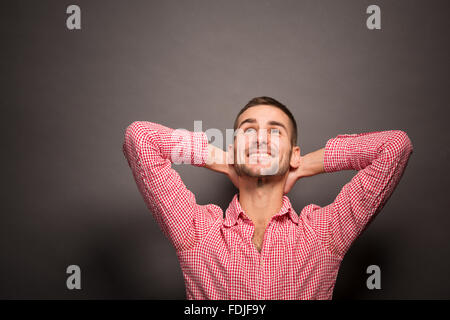 Handsome man looking upwards in studio Stock Photo