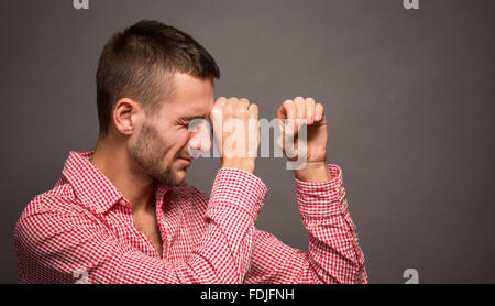 Man making binocular or tube from hands Stock Photo