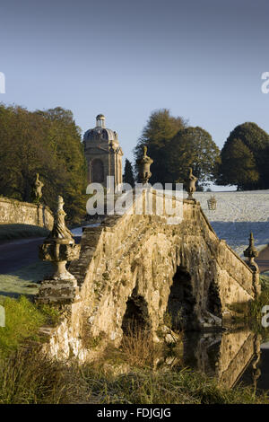 The Oxford Bridge with urns and rustic stonework on a frosty day at Stowe Landscape Gardens, Buckinghamshire.