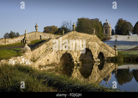 The Oxford Bridge with urns and rustic stonework on a frosty day at Stowe Landscape Gardens, Buckinghamshire.