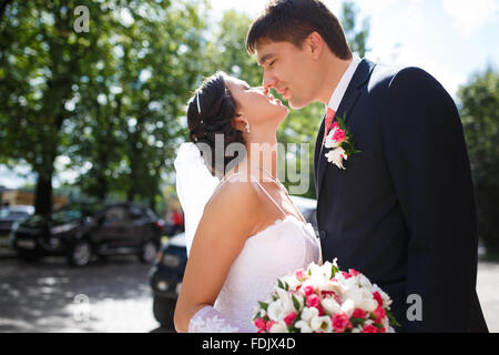 Wedding couple kissing on a street of town Stock Photo