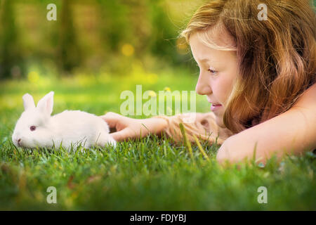 Girl stroking pet rabbit Stock Photo