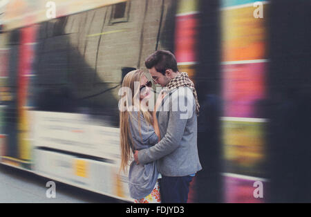 Young Couple embracing at train station, Seville, Spain Stock Photo