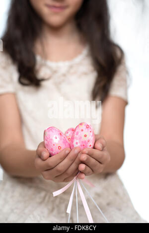 Girl holding a handful of Easter Eggs Stock Photo
