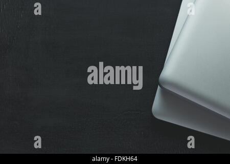 Two closed laptops on modern wooden desk Stock Photo