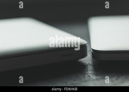 Two closed laptops on modern wooden desk Stock Photo