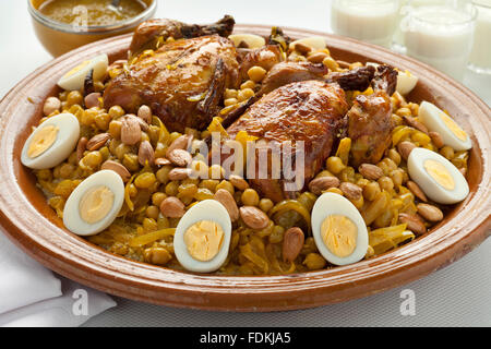 Couscous Tfaya, Moroccan Couscous with chicken and caramelized Onions, almonds and hard boiled eggs Stock Photo