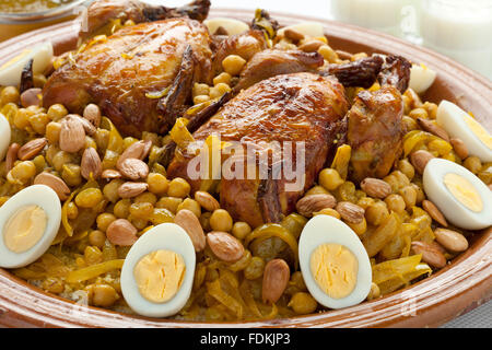 Couscous Tfaya, Moroccan Couscous with chicken and caramelized Onions, almonds and hard boiled eggs closeup Stock Photo