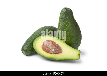 Whole and half fresh avocados on white background Stock Photo