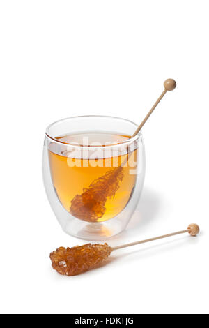 Tea with brown Rock candy stick on white background Stock Photo