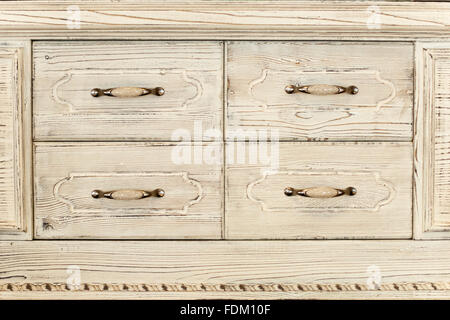 Part of an old white wooden cupboard with four drawers -old fashion, wooden texture, retro rustic stile Stock Photo
