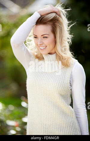 Smiling blonde teen girl 14-16 year old wearing stylish clothes posing  outdoors. Looking at camera. Autumn season Stock Photo - Alamy