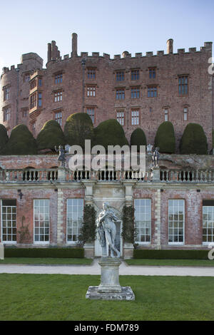 C18th lead statue of a shepherd by John Van Nost on the Orangery Terrace in spring at Powis Castle and Garden, Welshpool, Powys. The Orangery and the castle are in the background. Stock Photo
