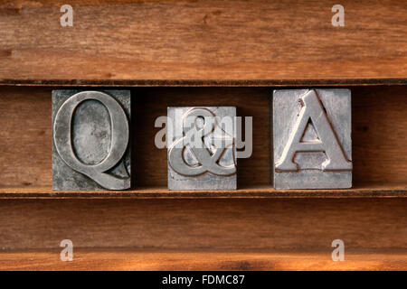 Questions and Answers abbreviation made from metallic letterpress type on wooden tray Stock Photo