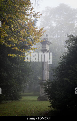 Stone sphinx by Benjamin Carter on fluted shafts on a foggy day in autumn in the grounds at Lacock Abbey, Wiltshire. Stock Photo