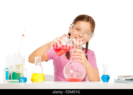 Pouring red liquid reactant from volumetric glass Stock Photo