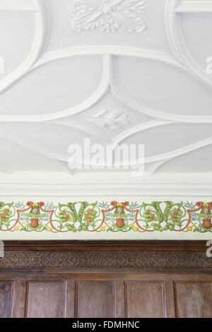 The plasterwork ceiling and newly-painted plaster frieze in the Tudor Bedroom at Avebury Manor, Wiltshire. Stock Photo