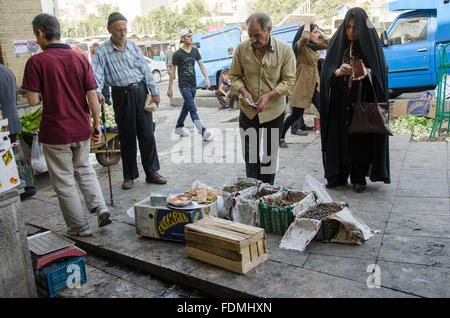 Old man selling Sour Cherries in Tajrish bazaar, Tehran, Iran Stock Photo