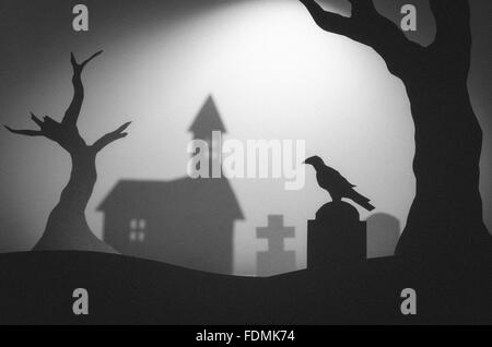 Halloween night in haunted dark graveyard with tombstones, raven and trees Stock Photo