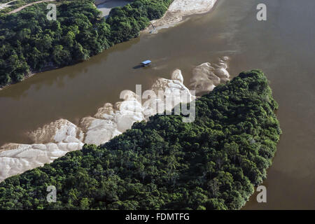 Aerial view of boat sailing in the White River and Amazon forest