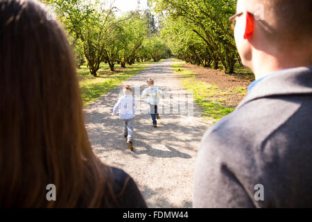 Family of four outdoors in a natural setting with nice light in a lifestyle portrait. Stock Photo