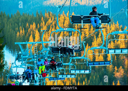 Skiers and snowboarders on a ski lift in Bukovel. Bukovel is the most popular ski resort in Ukr Stock Photo