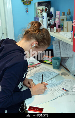 Teenage girl studies for A'levels in her bedroom MODEL RELEASED Stock Photo