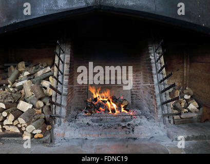 Blazing open Log fire in an Inglenook fireplace Stock Photo