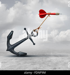 Challenges in business as a dart being slowed down by a heavy anchor as an adversity metaphor and symbol or overcoming a handicap to achieve your goal to reach the target. Stock Photo