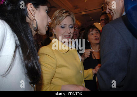 Long-time Hillary Clinton aide Huma Abedin, left, speaks to NY Senator Hillary Rodham Clinton, center, as she greets supporters on election night on November 7, 2006 at the NY Sheraton Hotel in Manhattan. Abedin later married now-disgraced U.S. Cong. Anthony Weiner. Abedin is in the soon-to-be released film 'Weiner' which chronicles the implosion of his campaign.  (© Frances M. Roberts)