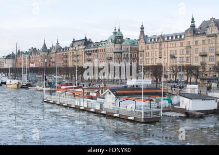 Stockholm, Sweden waterfront in winter - Strandbryggan Sea Club and buildings along Strandvagen Stock Photo