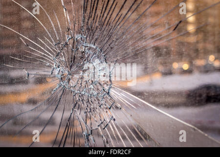 Cracked broken glass background with a city tower block backdrop, great idea for an image showing urban vandalism Stock Photo