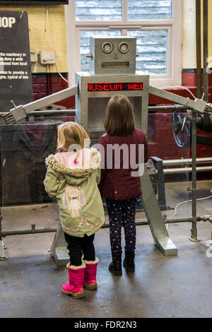 Two girls looking at a display at Bradford Industrial Museum, Bradford,West Yorkshire, UK Stock Photo