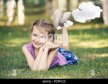 Little girl resting on meadow Stock Photo