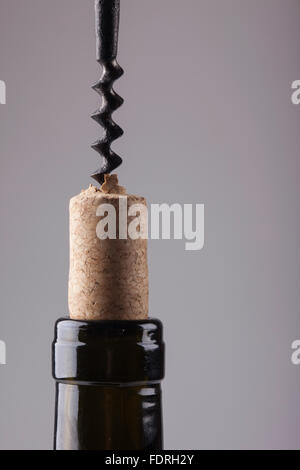 neck of a wine bottle old cork and corkscrew