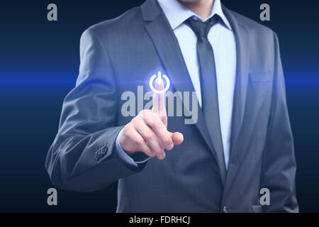 Businessman pressing power button concept Stock Photo