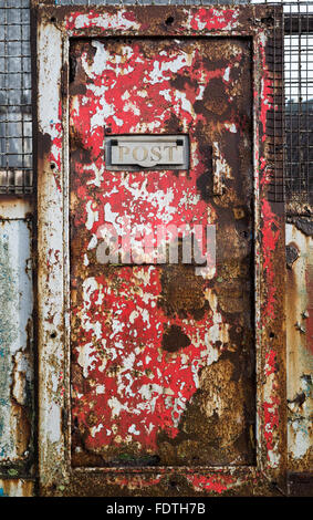 An old, rusty metal door and letterbox. Stock Photo