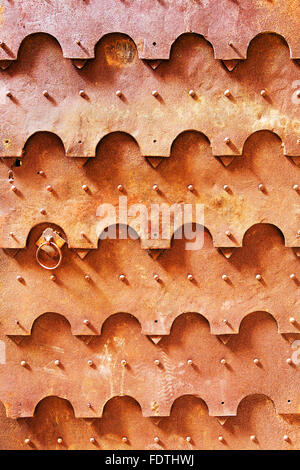 Creative vintage wrought iron door, iron surface is covered with rust. Stock Photo