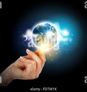 Human hand holding our planet earth glowing Stock Photo