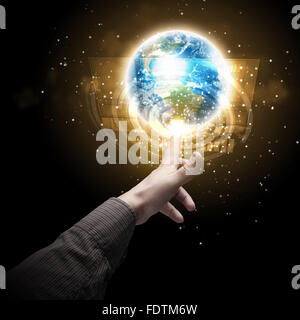 Human hand holding our planet earth glowing Stock Photo