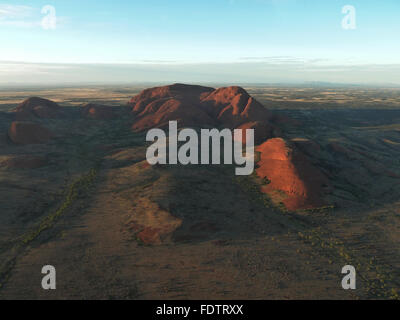 Aeriel view of Uluru (Ayers Rock) from helicopter at sunrise in summer. Stock Photo